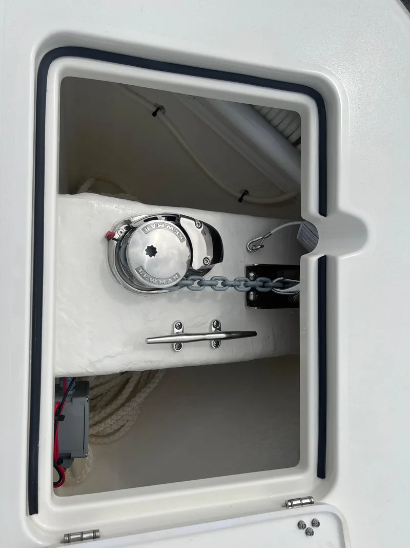 Slide: The Image of 2025 Cobia 240 Center Console anchor locker with chain and winch. - 30