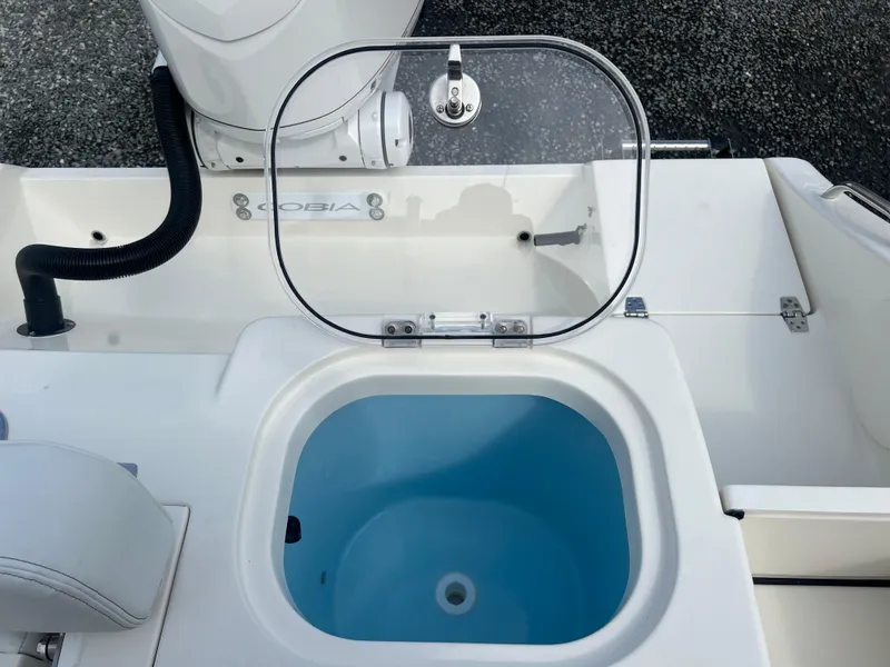 Slide: The Image of 2025 Cobia 240 Center Console livewell with open lid, showcasing interior. - 8