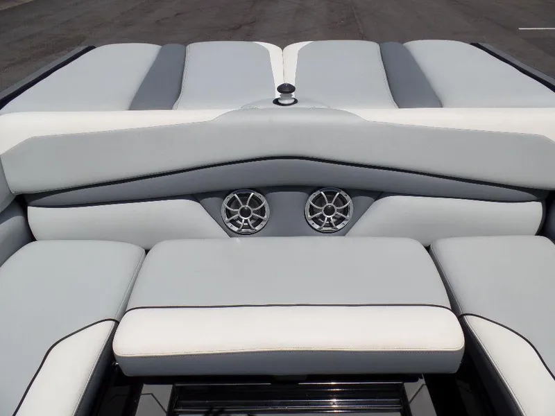 Slide: The Image of 2019 Axis A24 boat interior with cushioned seating and built-in speakers. - 13