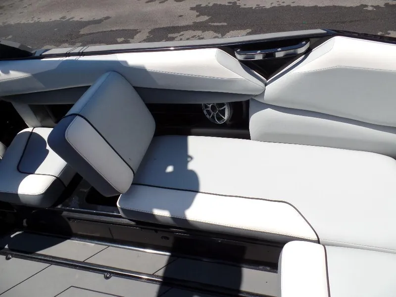 Slide: The Image of 2019 Axis A24 boat interior with white seating and speaker. - 17