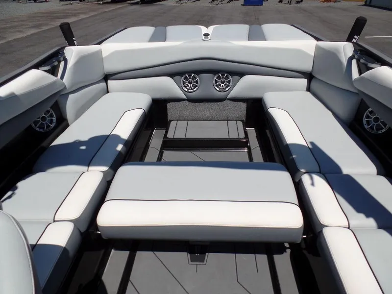 Slide: The Image of 2019 Axis A24 boat interior with white seating and built-in speakers. - 19