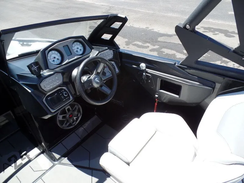 Slide: The Image of 2019 Axis A24 boat interior with steering wheel and dashboard controls. - 3