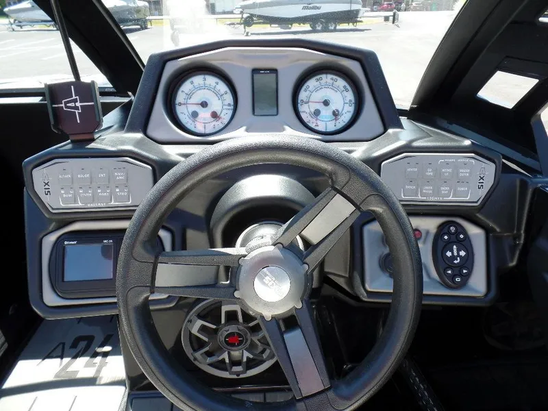 Slide: The Image of 2019 Axis A24 boat dashboard with steering wheel and control panels. - 4