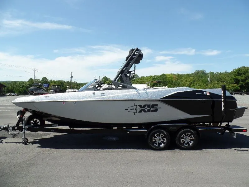 Slide: The Image of 2019 Axis A24 boat on trailer, parked outdoors under clear blue sky. - 7