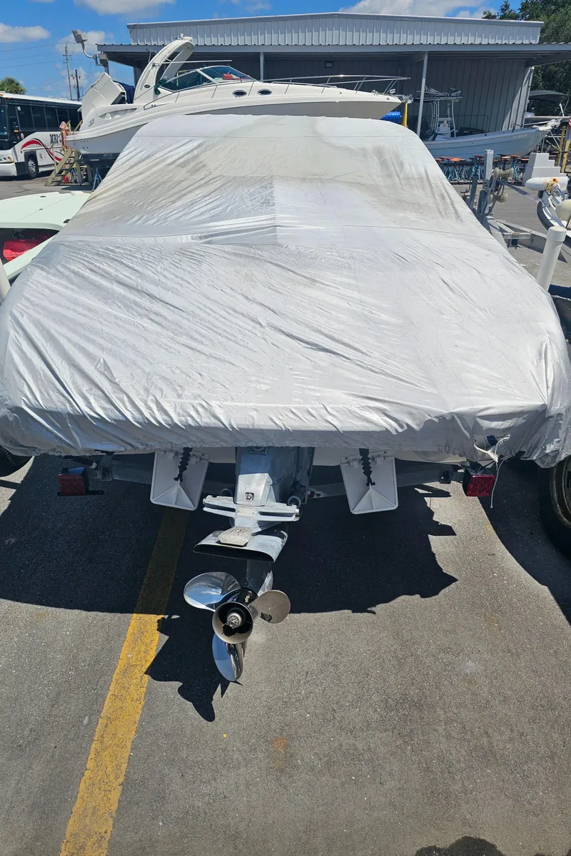 Slide: The Image of 2008 Stingray 185LS boat covered in protective tarp, parked outdoors. - 10