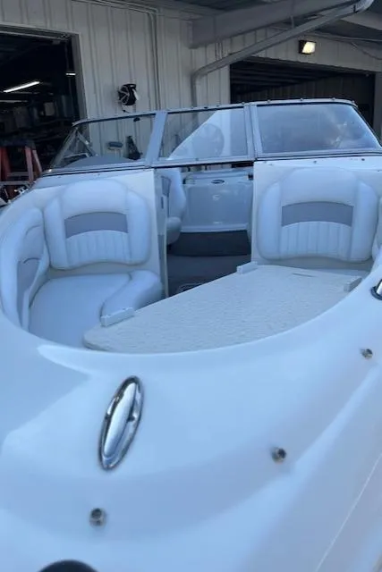 Slide: The Image of 2008 Stingray 185LS boat with white interior, docked in a covered area. - 2