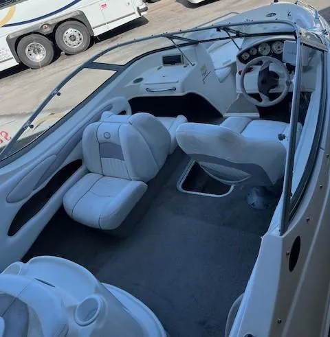 Slide: The Image of 2008 Stingray 185LS boat interior with white seating and dashboard. - 3