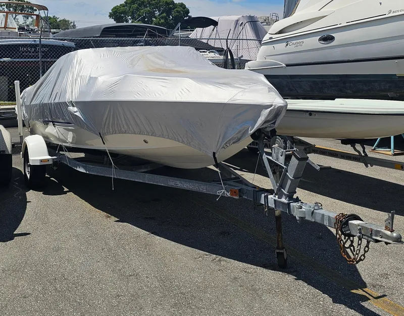 Slide: The Image of 2008 Stingray 185LS boat covered on trailer in storage lot. - 4