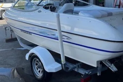 Slide: The Image of 2008 Stingray 185LS boat on trailer, white with blue accents, parked outdoors. - 6