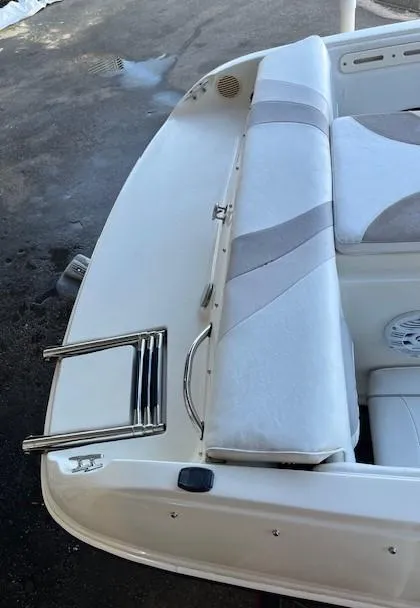 Slide: The Image of 2008 Stingray 185LS boat interior with white seating and swim ladder. - 8