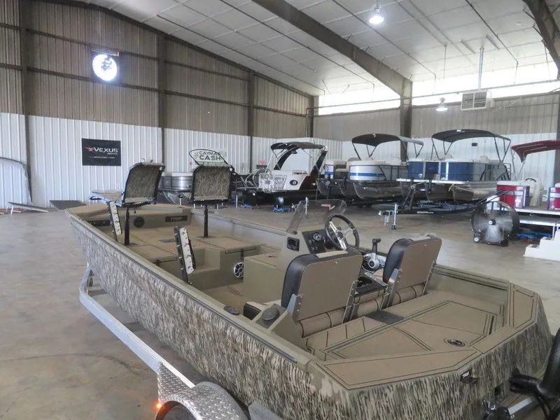 Slide: The Image of 2025 Thor Lake Hammer 1860 Side Console boat in showroom, camo design, spacious interior. - 14