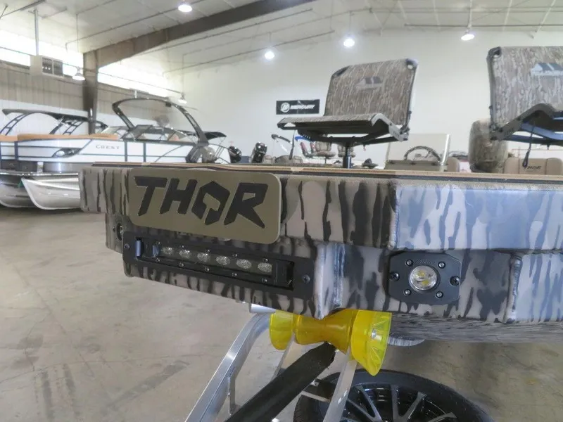 Slide: The Image of Thor LAKE HAMMER 1860 SIDE CONSOLE boat, 2025 model, in showroom with camouflage design. - 16
