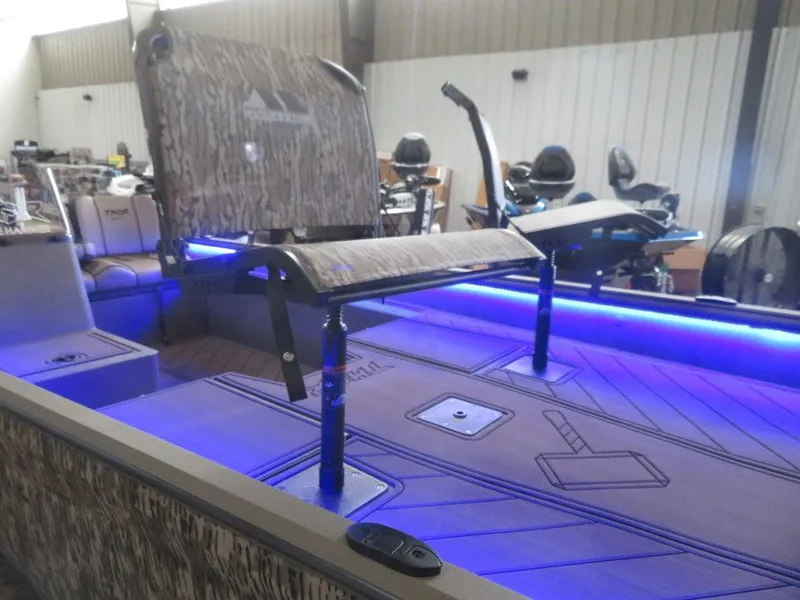 Slide: The Image of 2025 Thor Lake Hammer 1860 Side Console boat interior with blue LED lighting. - 3