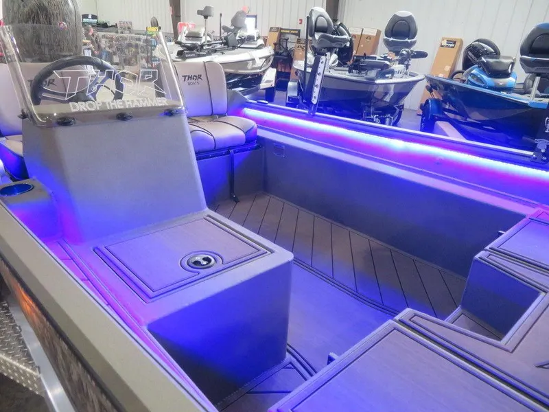 Slide: The Image of 2025 Thor Lake Hammer 1860 Side Console boat with illuminated interior and modern design. - 5