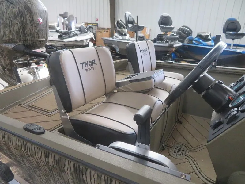 Slide: The Image of 2025 Thor Lake Hammer 1860 Side Console boat interior with steering wheel and seating. - 6