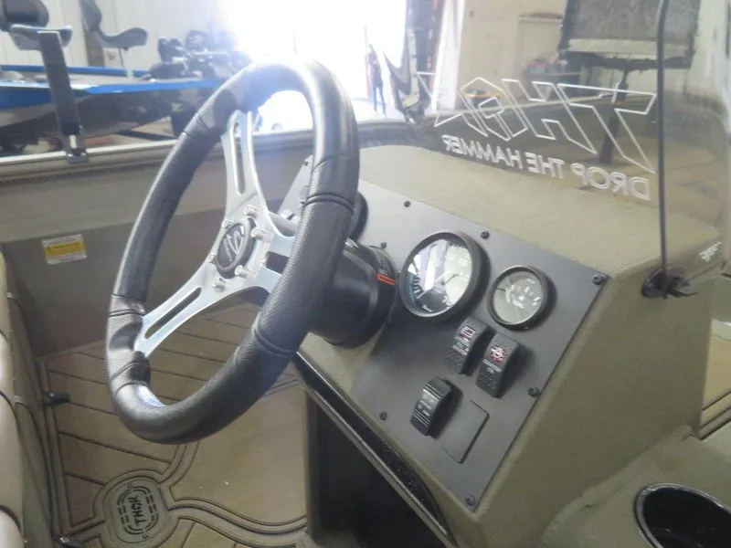 Slide: The Image of 2025 Thor Lake Hammer 1860 Side Console boat dashboard with steering wheel and gauges. - 7