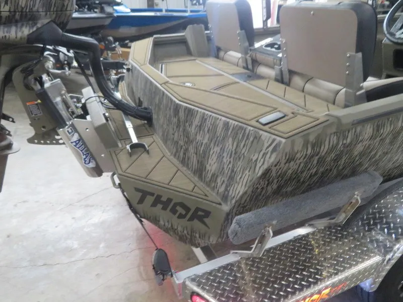 Slide: The Image of 2025 Thor Lake Hammer 1860 Side Console boat on trailer, camo design, rear view. - 8