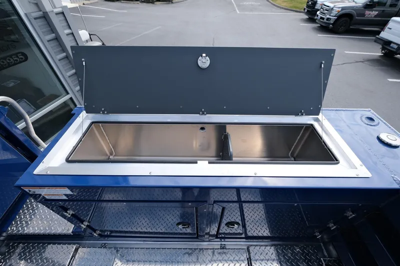 Slide: The Image of 2024 Hewescraft 250 Pacific Explorer boat storage compartment with stainless steel interior. - 10