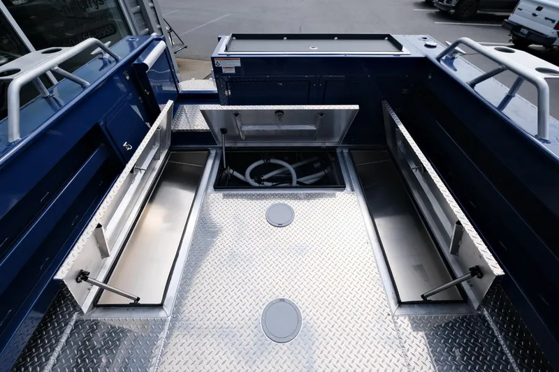 Slide: The Image of 2024 Hewescraft 250 Pacific Explorer boat deck with storage compartments open. - 20