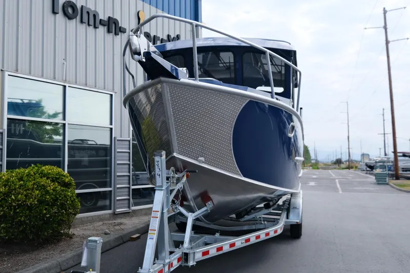 Slide: The Image of 2024 Hewescraft 250 Pacific Explorer boat on trailer outside a building. - 3