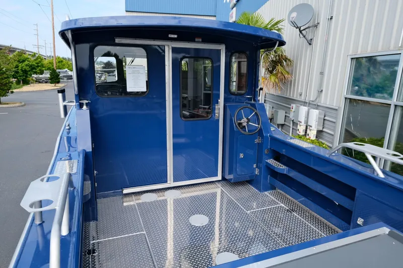 Slide: The Image of 2024 Hewescraft 250 Pacific Explorer boat, blue exterior, spacious deck, modern design. - 7