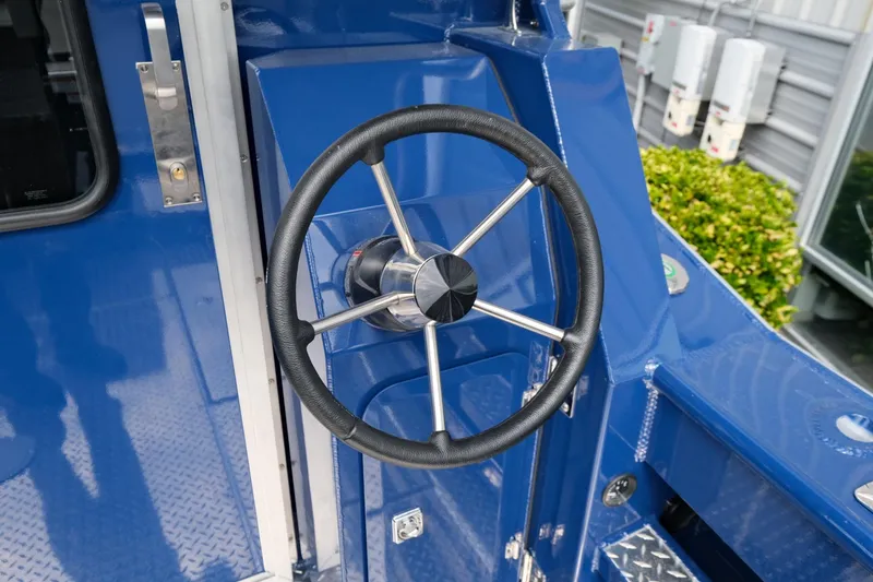 Slide: The Image of 2024 Hewescraft 250 Pacific Explorer steering wheel, blue interior detail. - 8