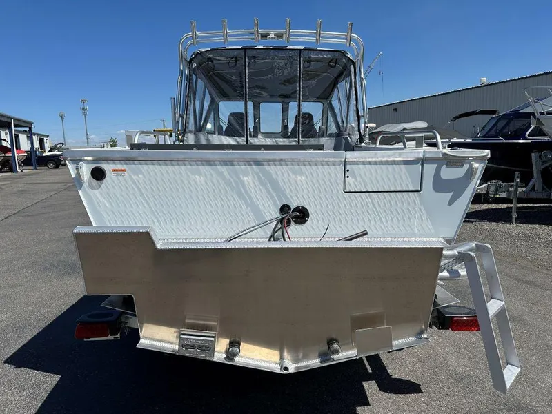 Slide: The Image of 2024 Hewescraft 210 Sea Runner w/ET, rear view, parked outdoors on a sunny day. - 3