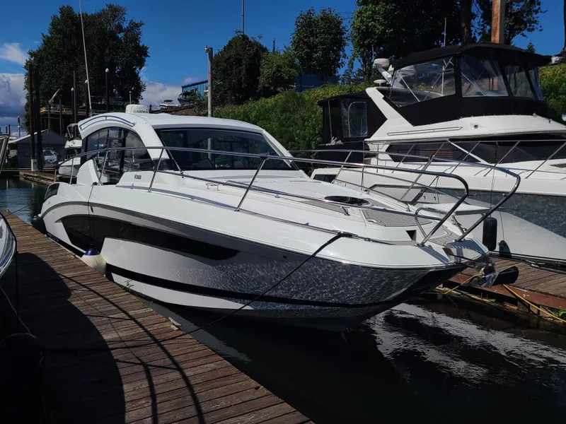 The Image of 2021 Four Winns Vista 355 Coupe OB docked at marina, sleek design, sunny day. - 0
