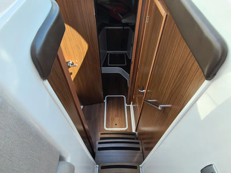 Slide: The Image of Interior view of 2021 Four Winns Vista 355 Coupe OB, featuring wooden doors and steps. - 12