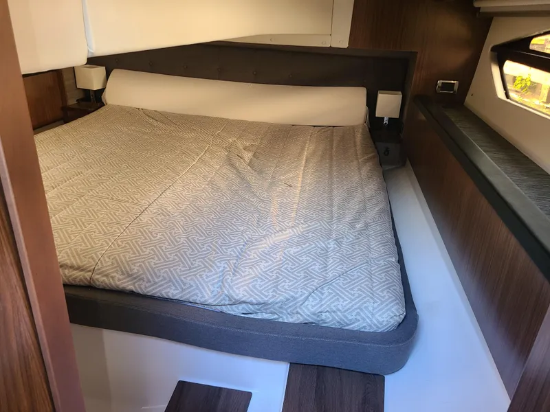 Slide: The Image of 2021 Four Winns Vista 355 Coupe OB cabin with a cozy bed and modern interior design. - 13