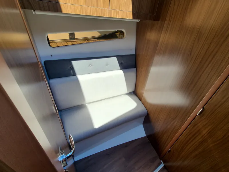 Slide: The Image of 2021 Four Winns Vista 355 Coupe OB interior seating with wood paneling and modern design. - 14