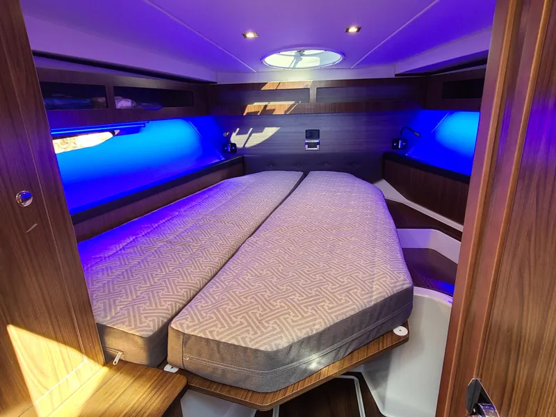 Slide: The Image of Interior cabin of 2021 Four Winns Vista 355 Coupe OB with ambient blue lighting. - 19
