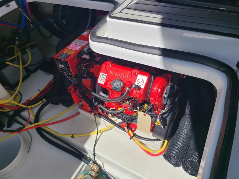 Slide: The Image of Engine compartment of 2021 Four Winns Vista 355 Coupe OB with visible wiring and components. - 23