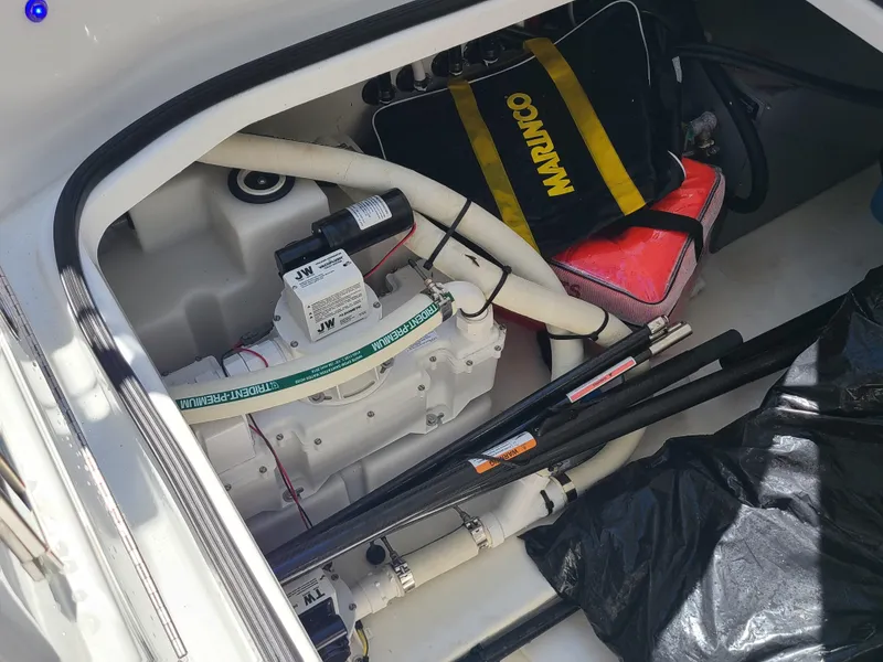 Slide: The Image of 2021 Four Winns Vista 355 Coupe OB storage compartment with equipment and accessories. - 24