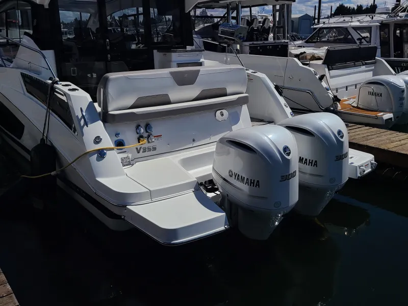 Slide: The Image of 2021 Four Winns Vista 355 Coupe OB with twin Yamaha outboard engines docked at marina. - 3