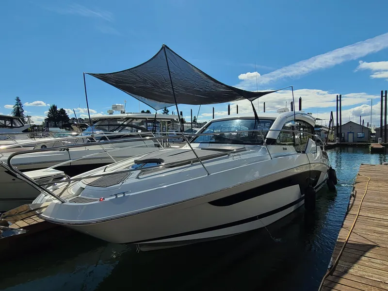 Slide: The Image of 2021 Four Winns Vista 355 Coupe OB docked under a sunshade on a sunny day. - 5