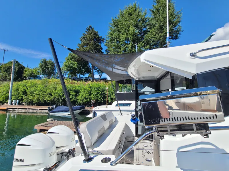 Slide: The Image of 2021 Four Winns Vista 355 Coupe OB docked, featuring outdoor seating and dual Yamaha outboard engines. - 6