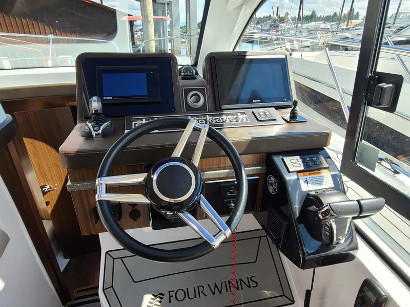 Slide: The Image of 2021 Four Winns Vista 355 Coupe OB helm with modern controls and navigation displays. - 9