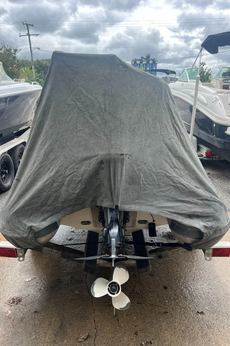 Slide: The Image of 2017 Walker Bay Generation 340 DLX boat covered, parked outdoors on a trailer. - 18