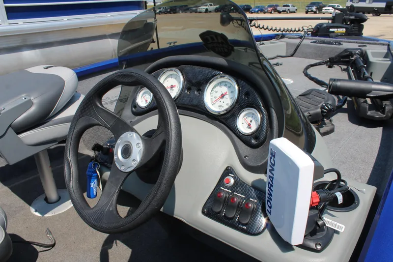 Slide: The Image of 2015 Tracker Pro Team 175 TF boat dashboard with steering wheel and gauges. - 13