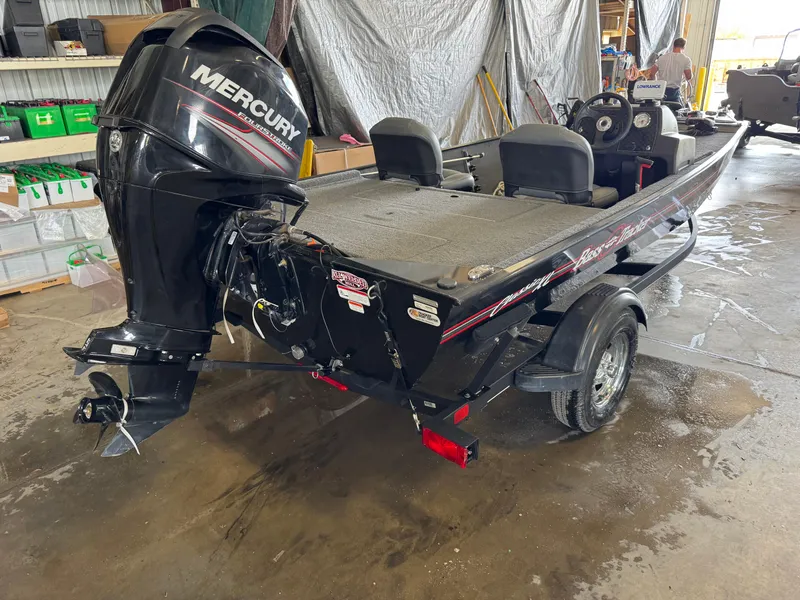 Slide: The Image of 2021 Tracker Bass Tracker Classic XL boat with Mercury engine in a garage. - 5