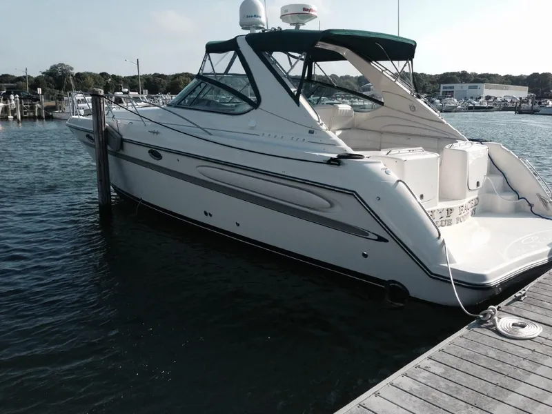 The Image of 1996 Maxum 4100 SCR yacht docked at a marina, featuring sleek design and spacious deck. - 1