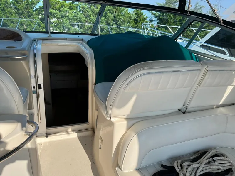Slide: The Image of 1996 Maxum 4100 SCR boat interior with white seating and open cabin door. - 10