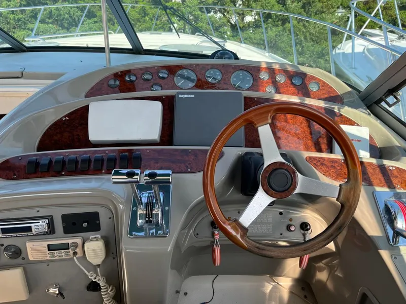 Slide: The Image of Cockpit of 1996 Maxum 4100 SCR boat with wooden steering wheel and control panel. - 11