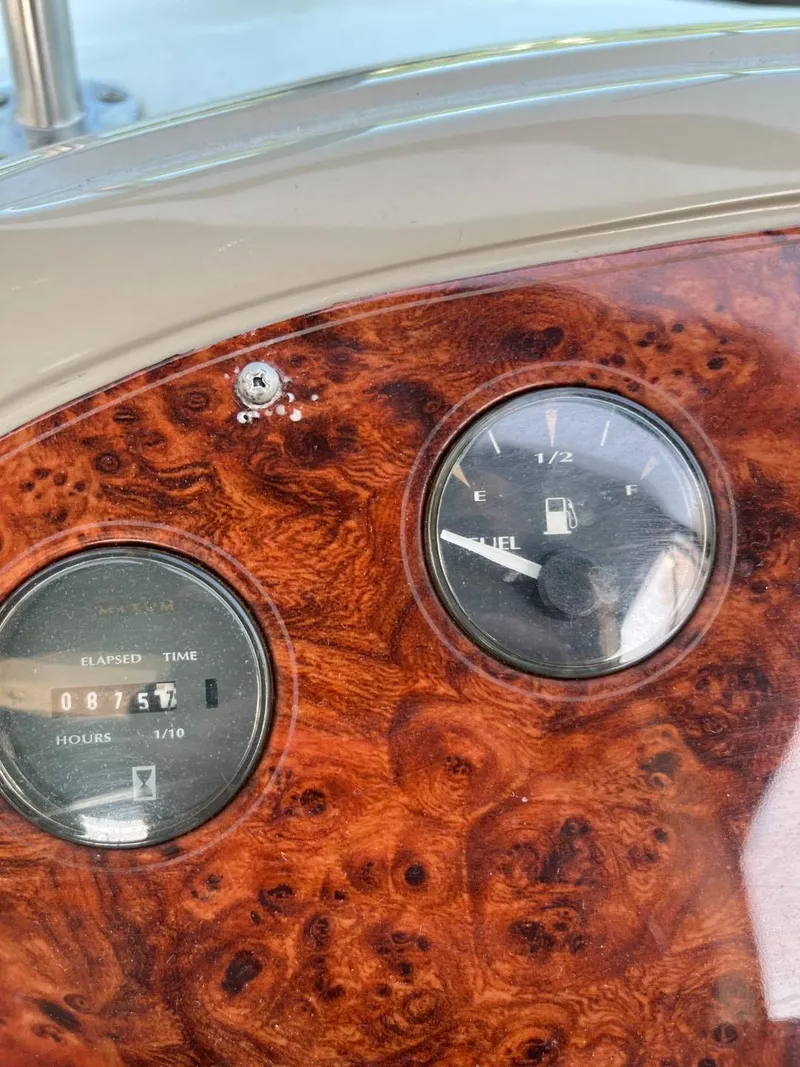 Slide: The Image of Dashboard of a 1996 Maxum 4100 SCR boat with fuel and elapsed time gauges. - 12