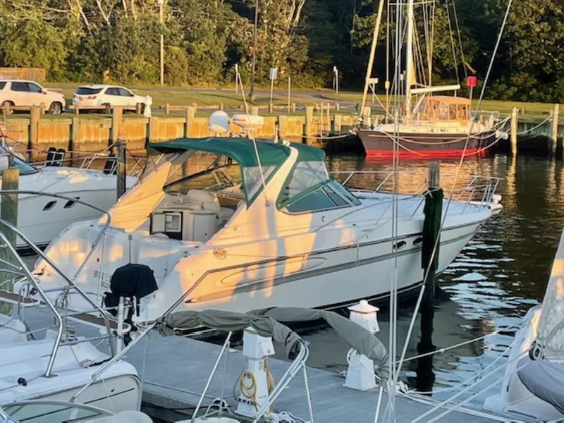 Slide: The Image of 1996 Maxum 4100 SCR yacht docked at a marina during sunset. - 2