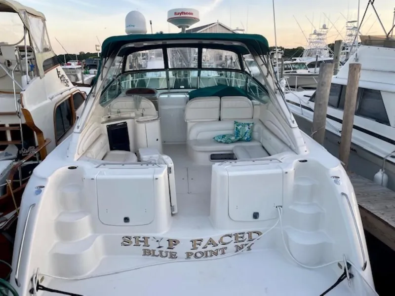 Slide: The Image of 1996 Maxum 4100 SCR yacht docked, featuring spacious seating and nautical decor. - 3