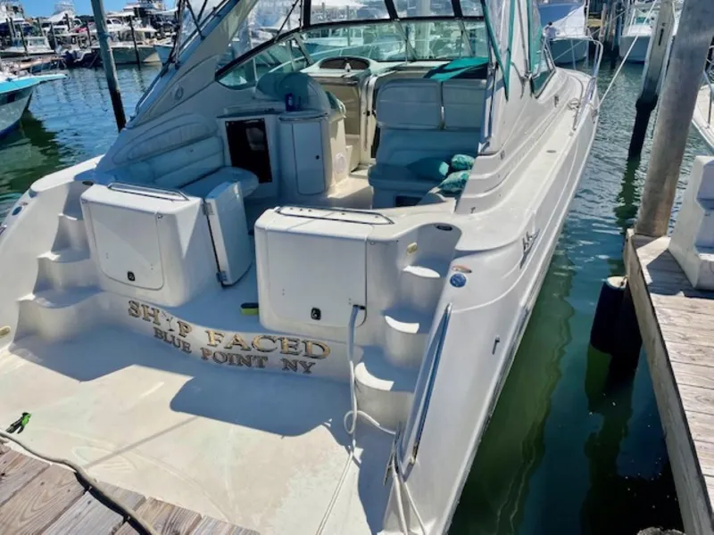 Slide: The Image of 1996 Maxum 4100 SCR yacht docked at marina, featuring spacious deck and seating area. - 4