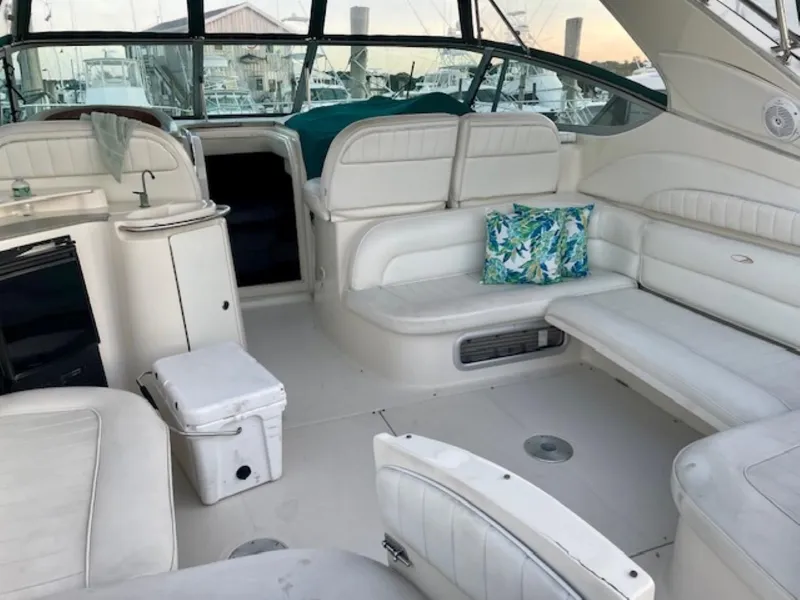Slide: The Image of 1996 Maxum 4100 SCR yacht interior with white seating and a floral cushion. - 5