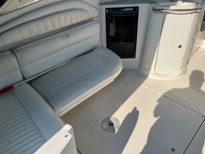 Slide: The Image of 1996 Maxum 4100 SCR boat interior with white seating and storage compartments. - 6